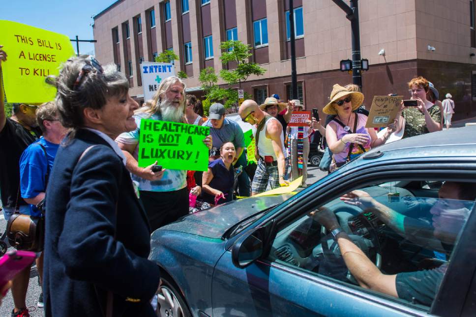 Chris Detrick  |  The Salt Lake Tribune
Protesters block traffic on State Street during a rally against the Senate GOP health care bill outside the Wallace Bennett Federal Building on Tuesday, June 27, 2017.